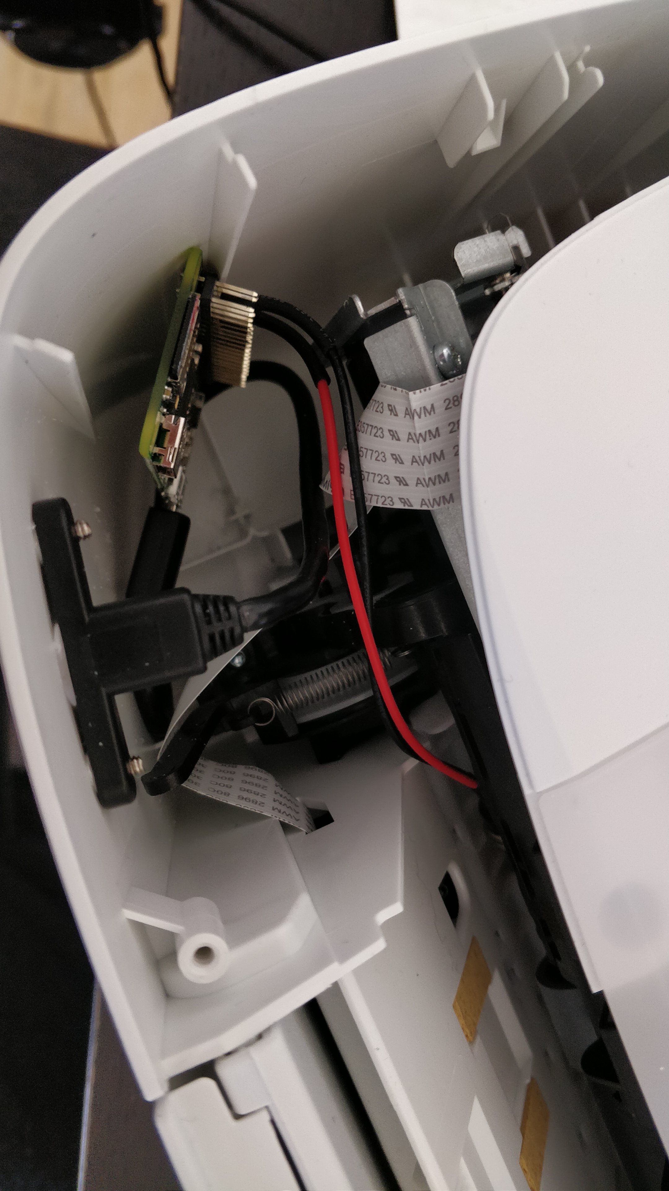 An open printer, with a raspberry pi crammed into it